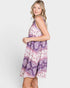 Woman wearing a purple patterned dress on a white background