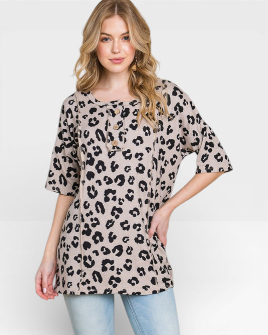 Woman wearing a leopard print top on a white background