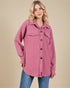 Woman wearing a pink patterned jacket with buttons on a beige background