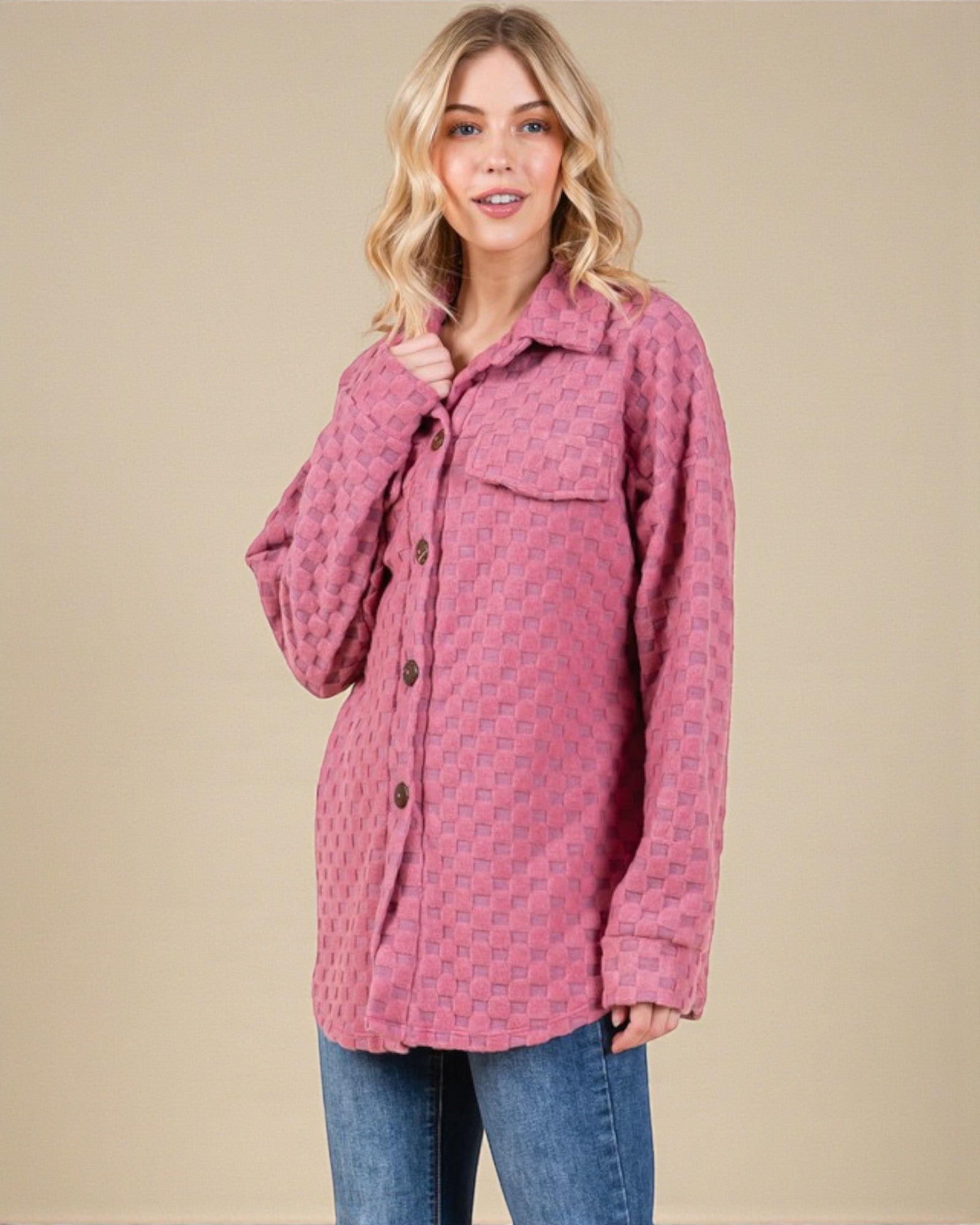 Woman wearing a pink patterned jacket on a beige background