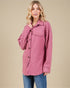 Woman wearing a pink patterned jacket on a beige background