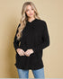 Woman wearing a black hoodie against a beige background
