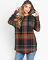 A woman wearing a black hooded pullover sweatshirt with a red, yellow, and white plaid pattern, paired with blue jeans, against a plain white background.