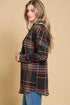 Woman wearing a plaid shirt against a beige background