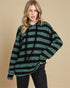 Woman wearing a green and black striped hoodie against a beige background