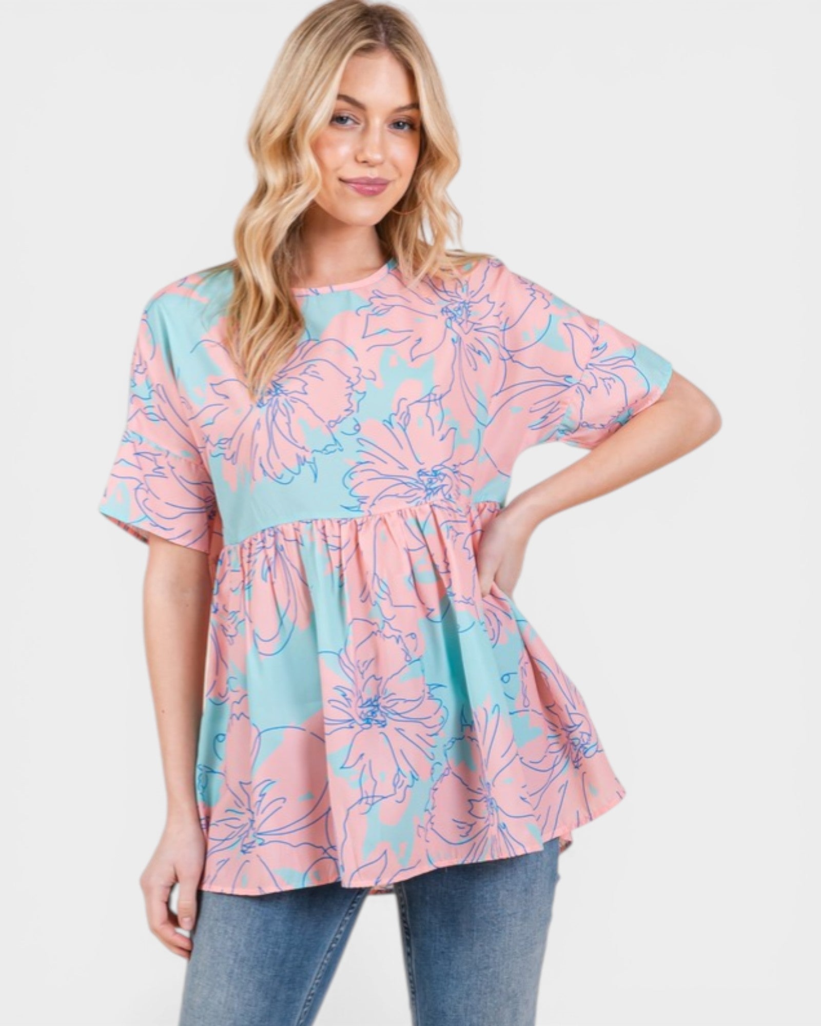 Woman wearing a pink and blue floral blouse on a white background