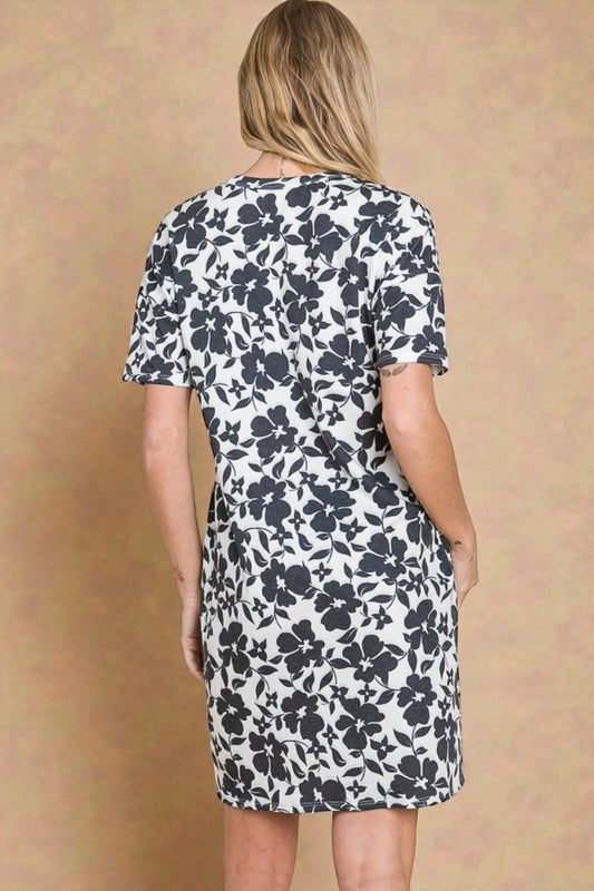 Woman wearing a floral dress against a beige background