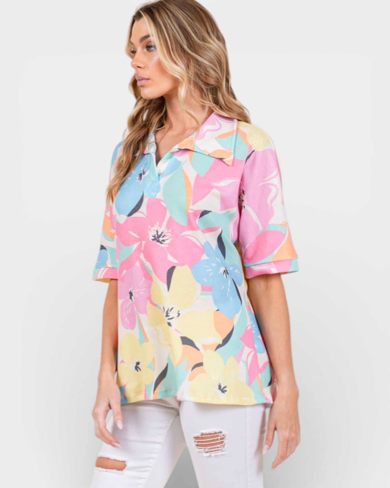 Woman wearing a colorful floral blouse on a white background