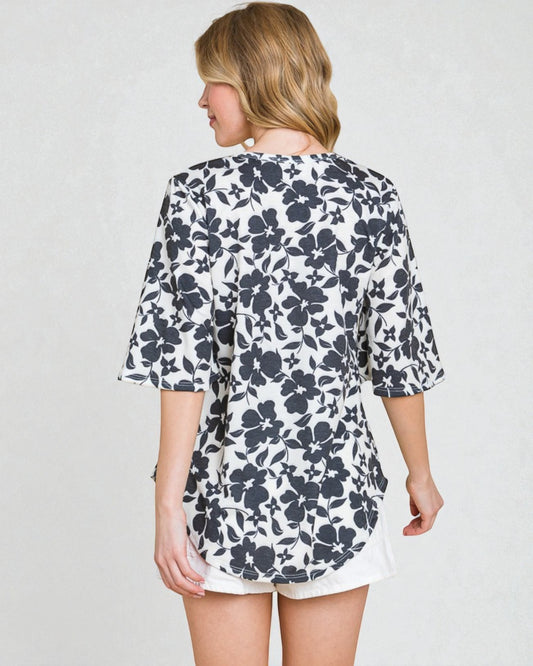 Woman wearing a floral dress with a plain background