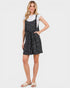 Woman wearing a black polka dot dress on a white background