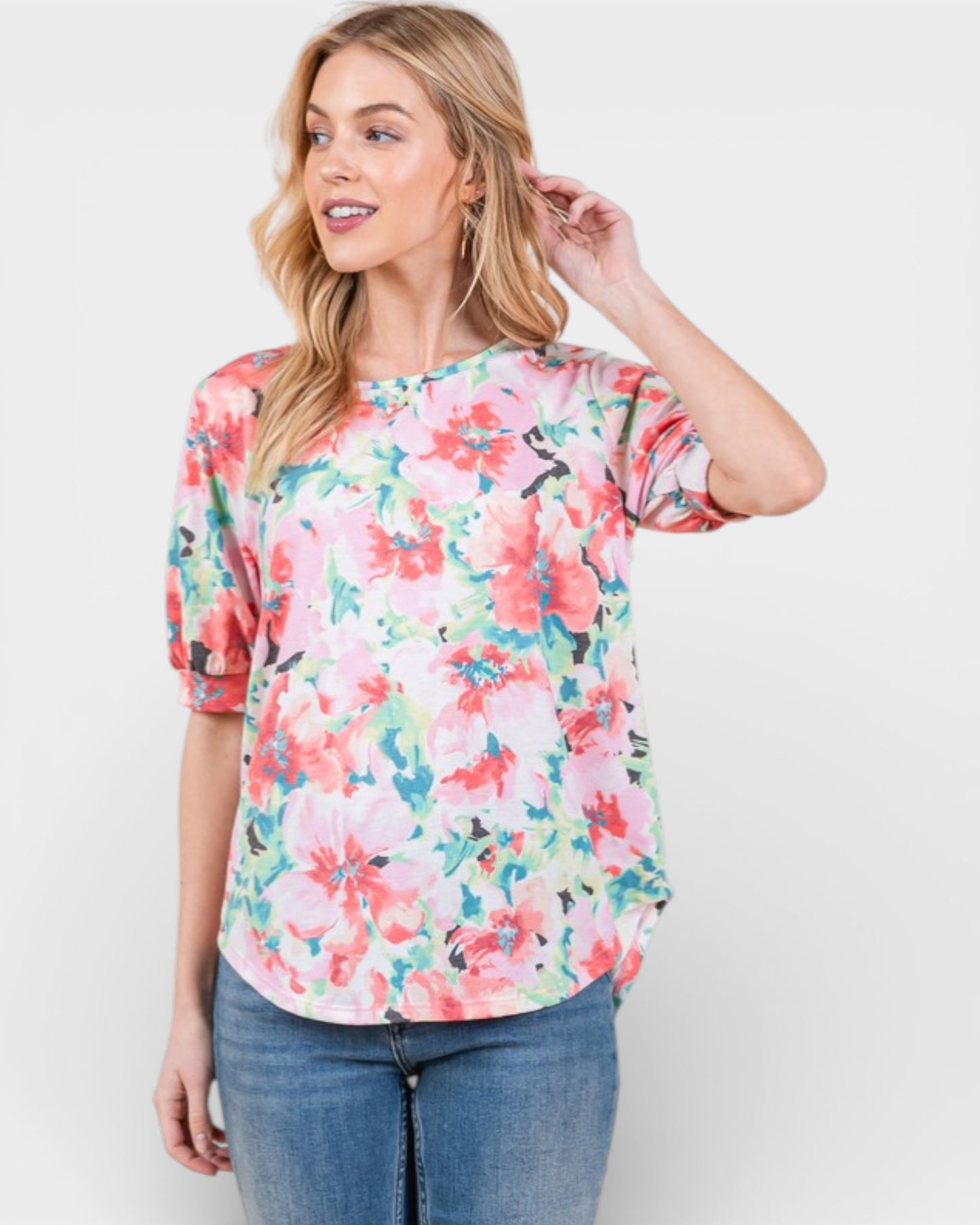 Woman wearing a floral blouse with a plain background