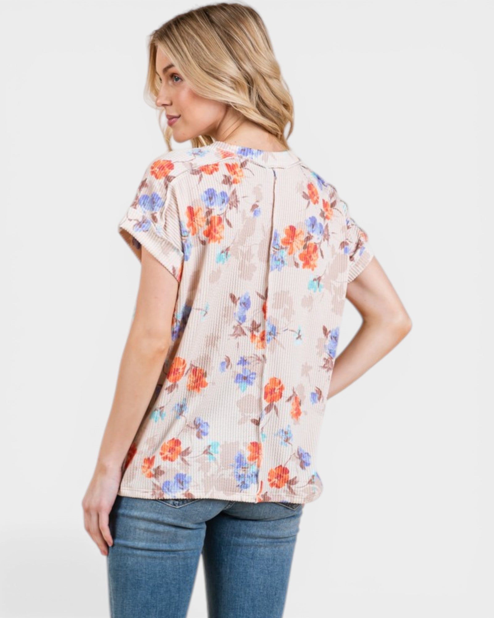 Woman wearing a floral blouse with a plain background