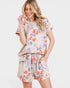 Woman wearing a floral outfit on a white background
