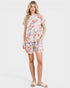 Woman wearing a floral pajama set on a white background