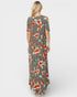 Woman wearing a floral maxi dress on a white background