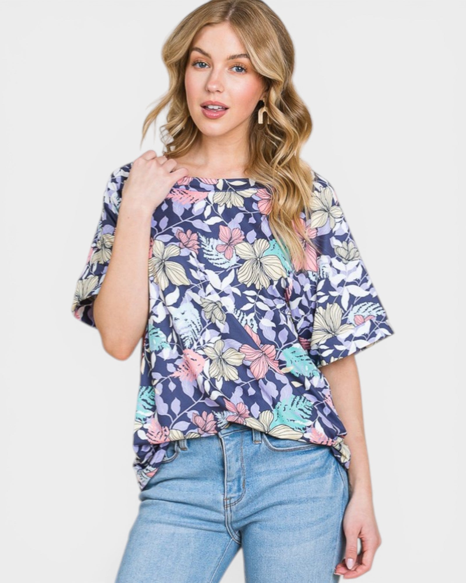 Woman wearing a floral blouse with a plain background