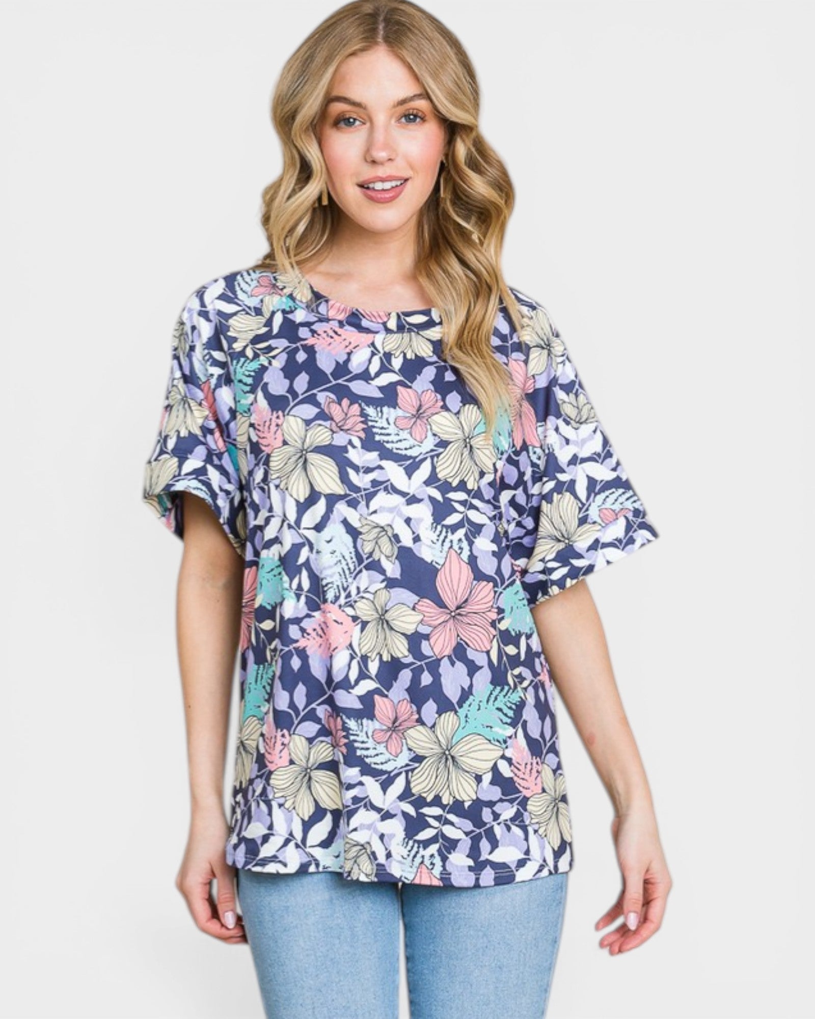 Woman wearing a floral patterned shirt on a plain background