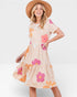 Woman wearing a floral dress with a white background