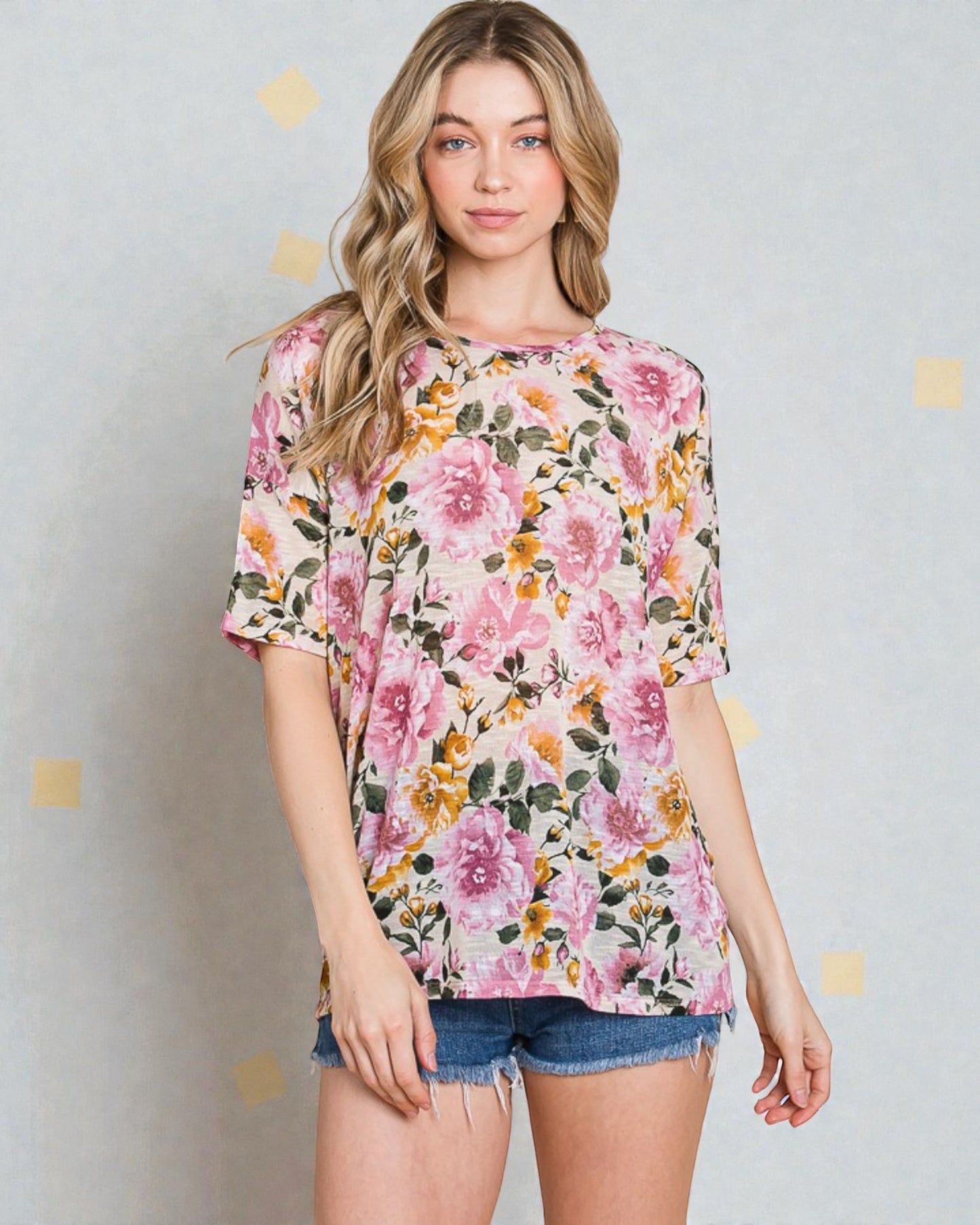 Woman wearing a floral blouse with a plain background