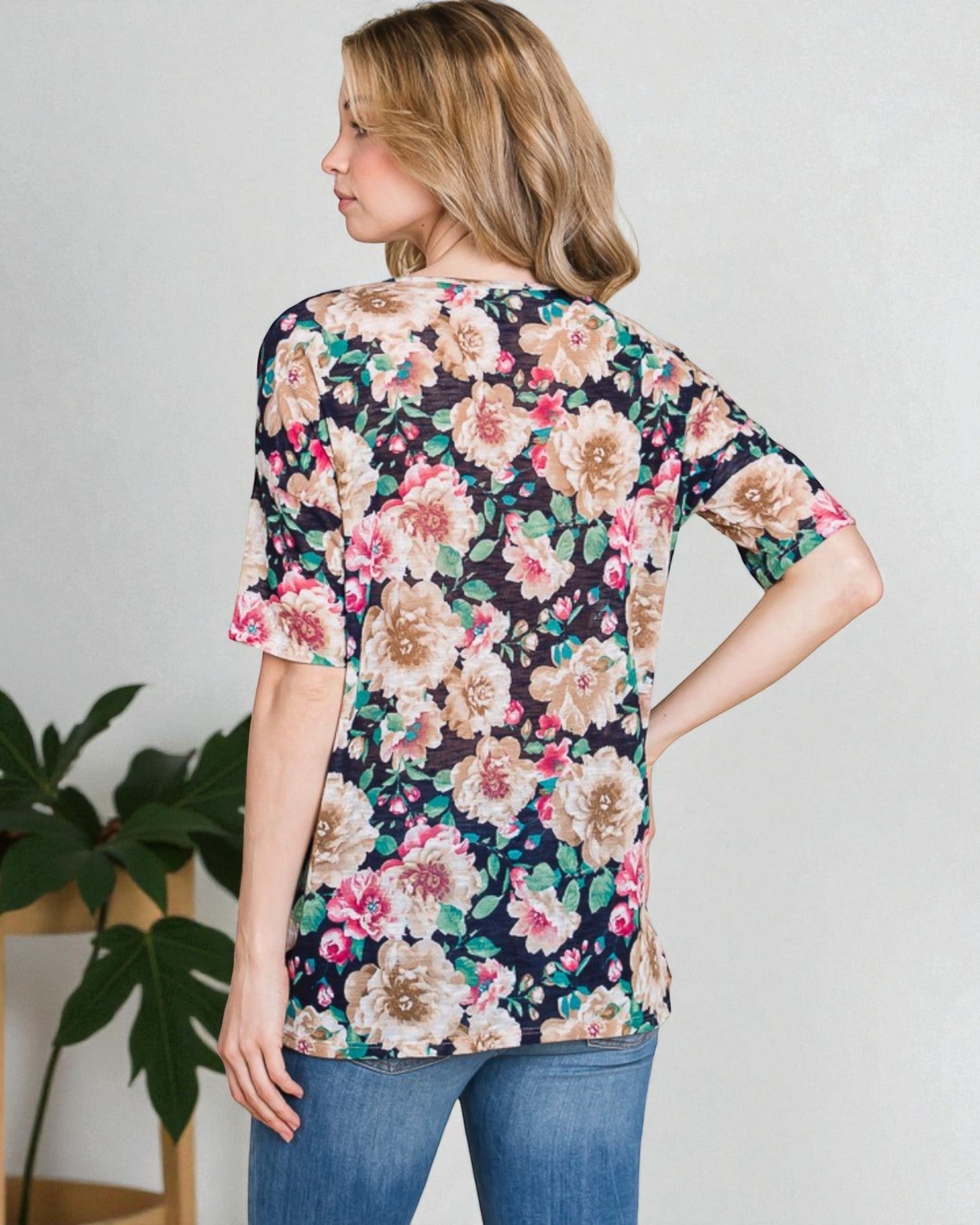 Woman wearing a floral blouse with a neutral background