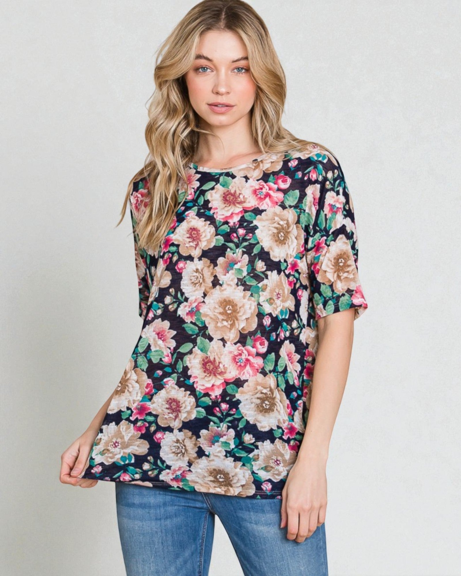 Woman wearing a floral blouse with a plain background