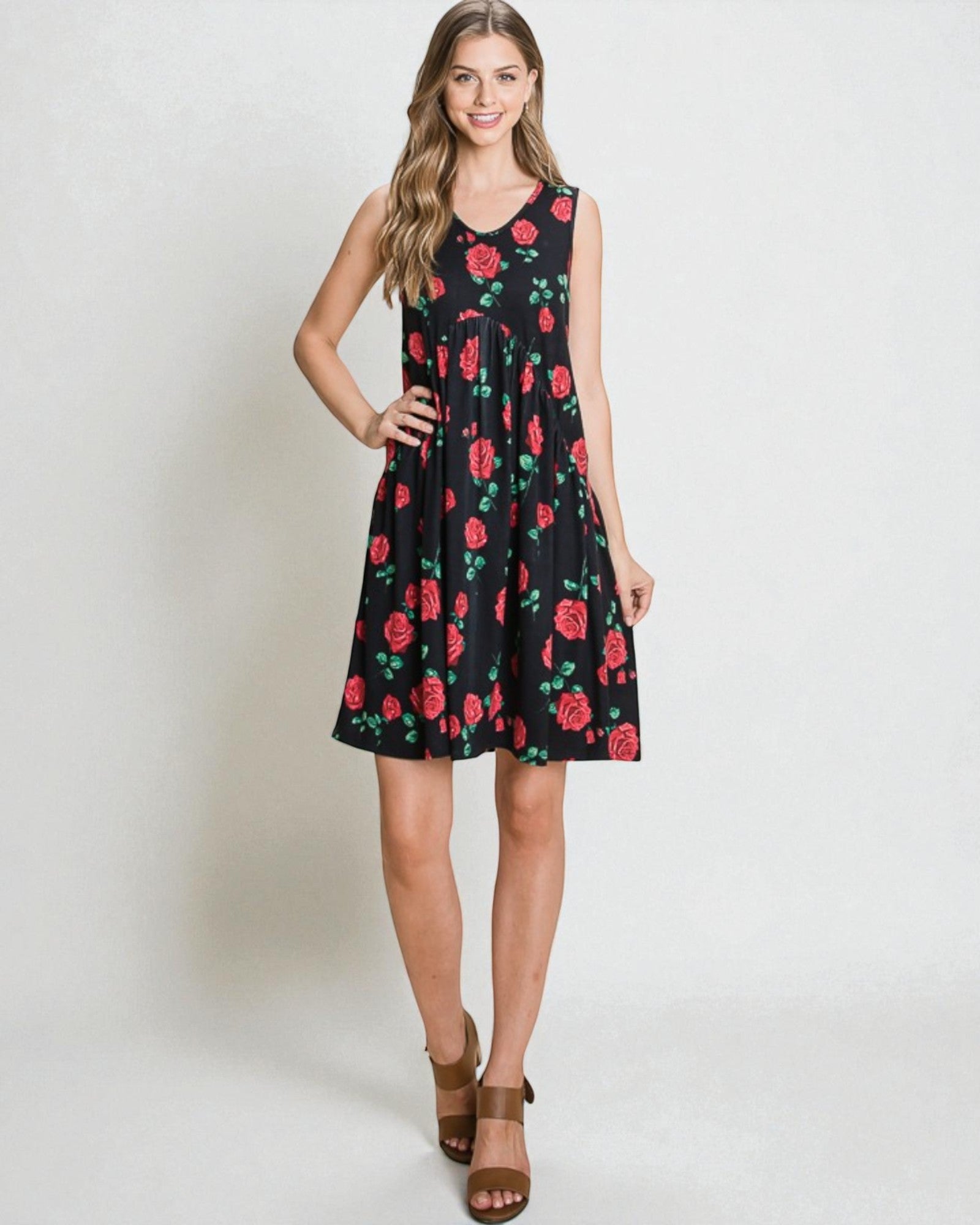 Woman wearing a black dress with red floral pattern on a white background