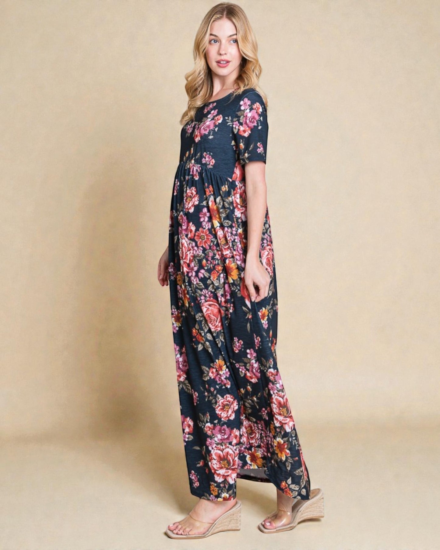 Woman wearing a floral maxi dress against a beige background
