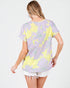 Woman wearing a floral patterned t-shirt on a white background