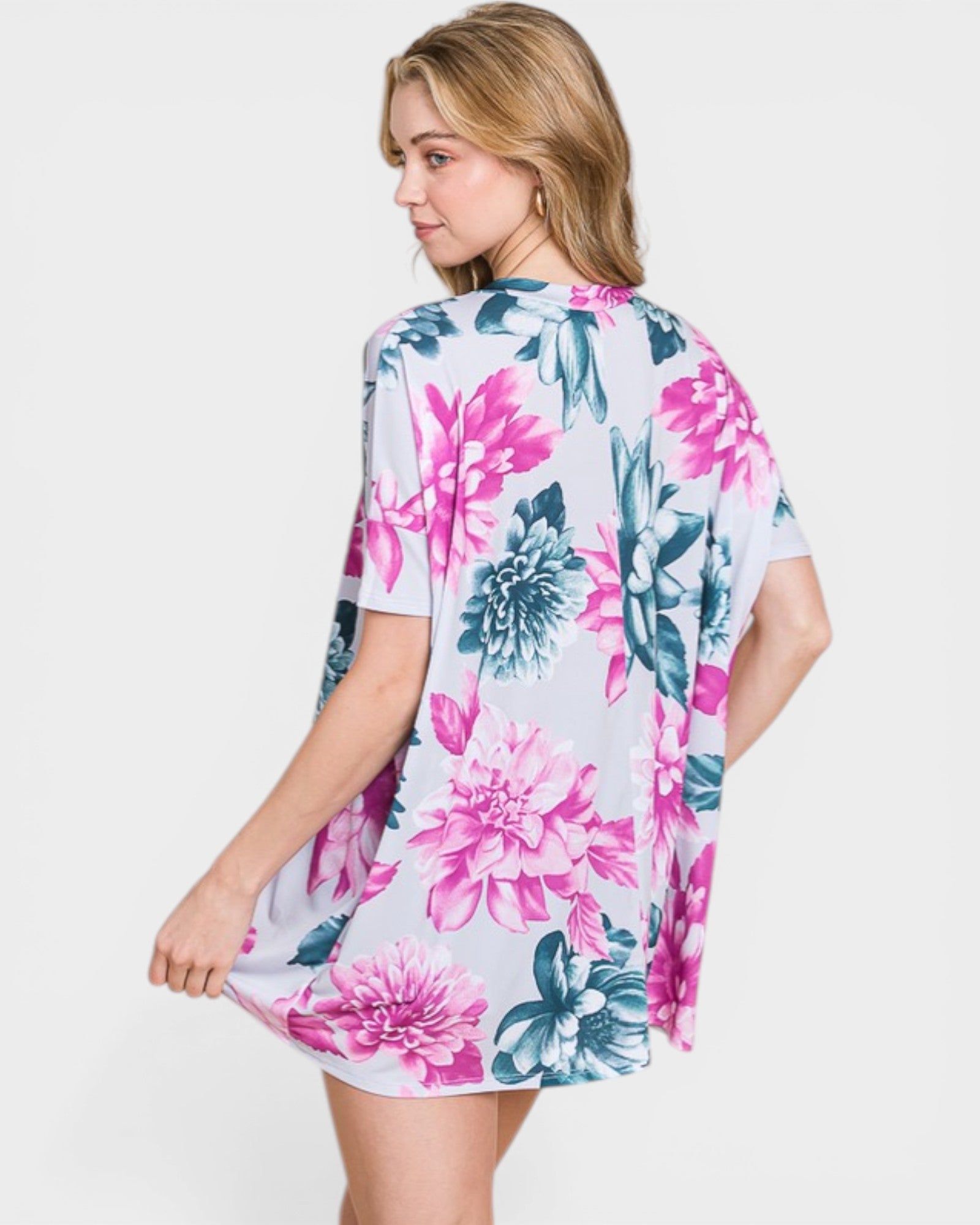 Woman wearing a floral kimono-style garment on a white background