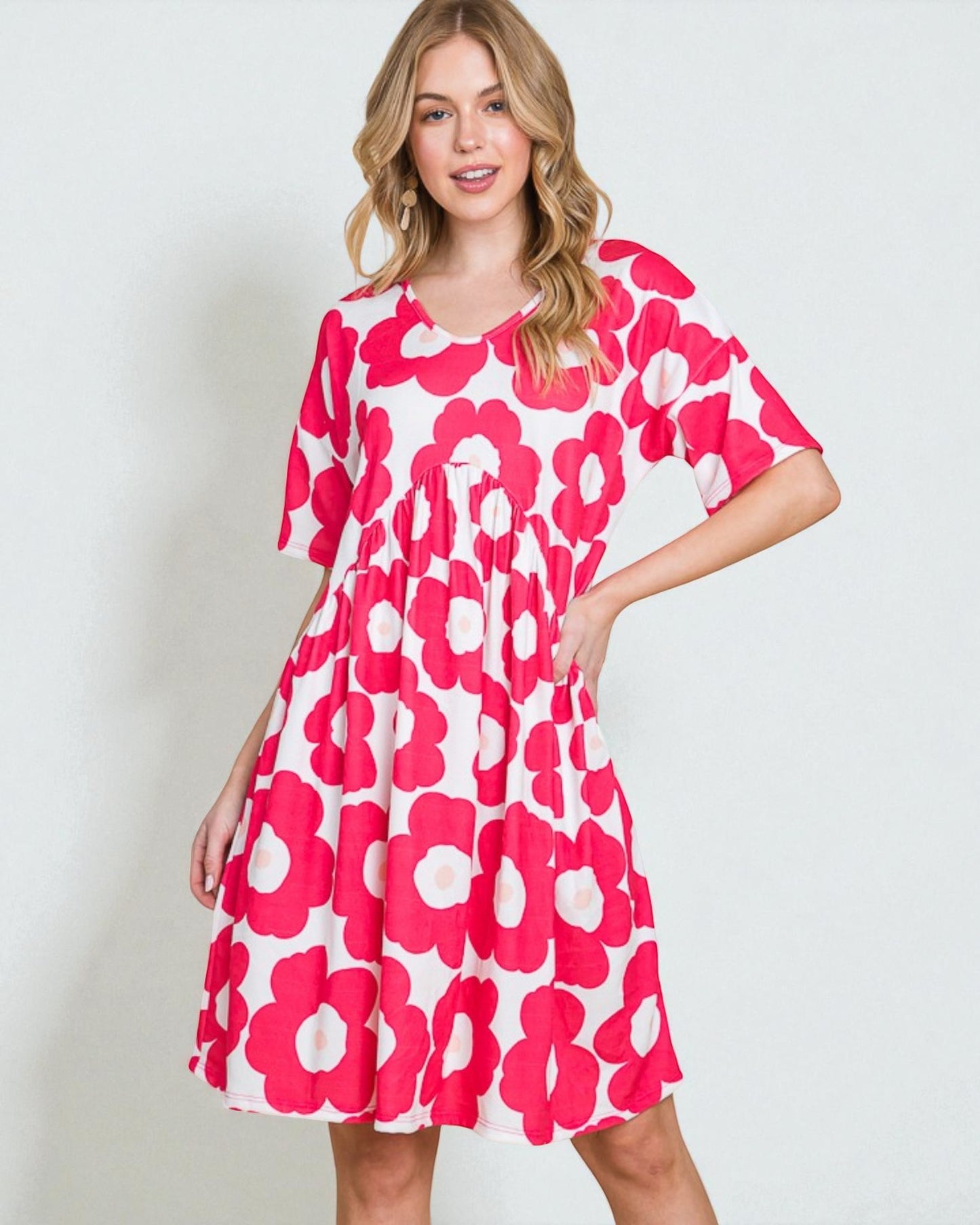 Woman wearing a pink floral dress on a white background