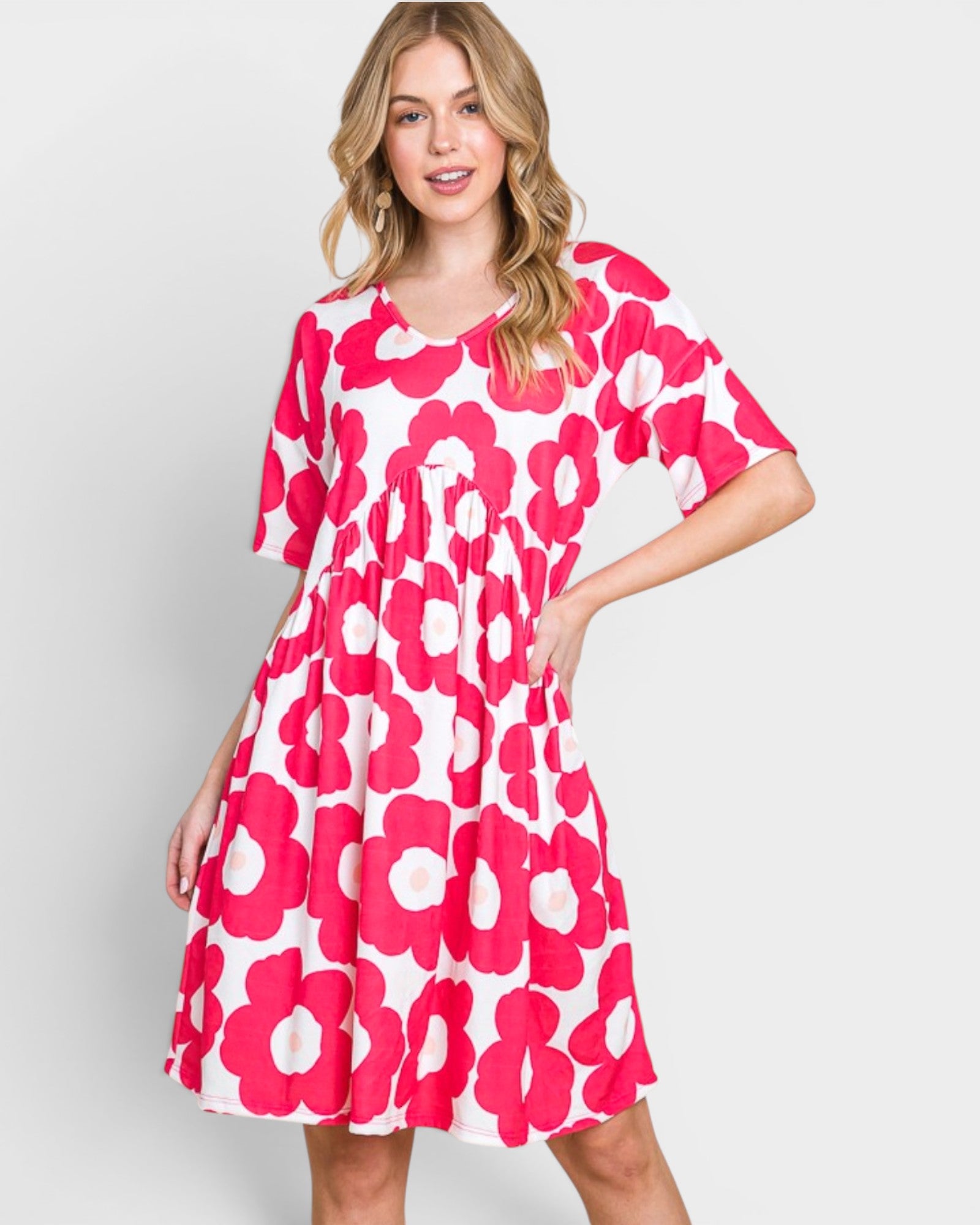 Woman wearing a pink floral dress on a light gray background