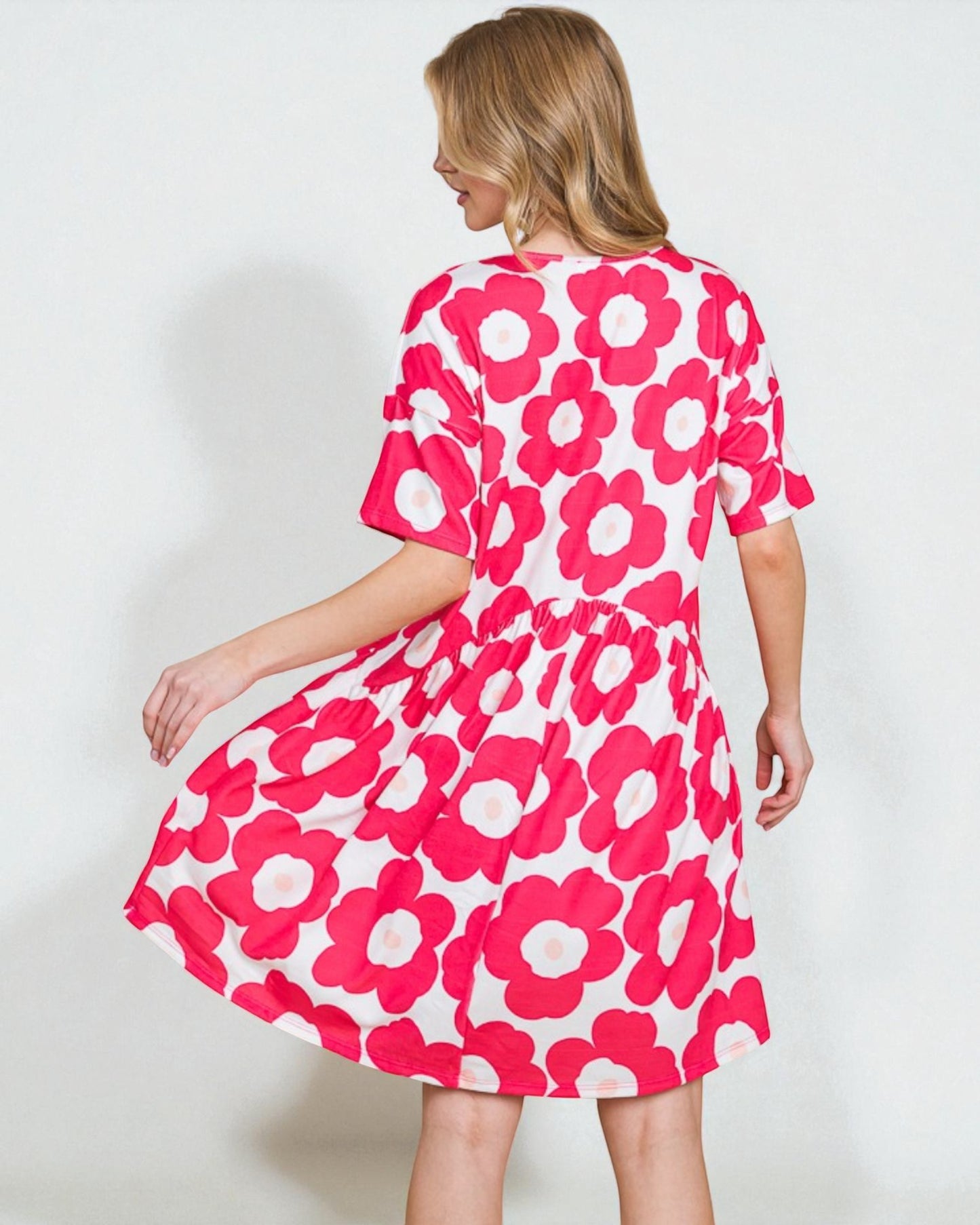 Woman wearing a pink floral dress on a white background