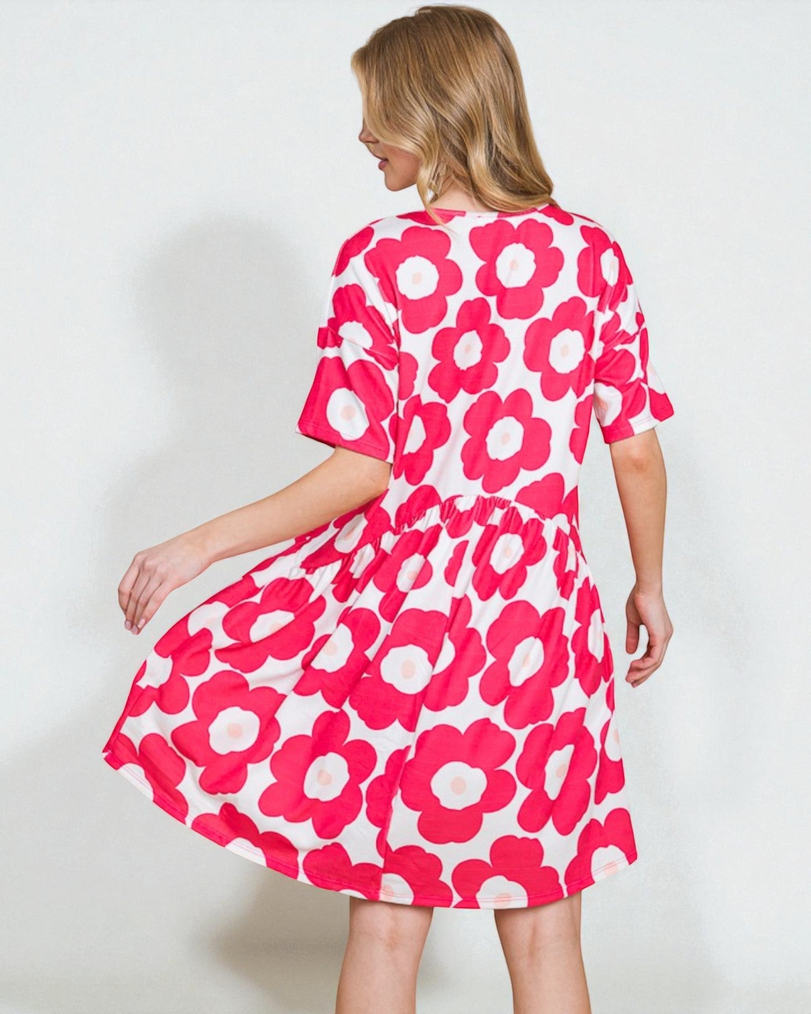 Woman wearing a pink floral dress on a white background
