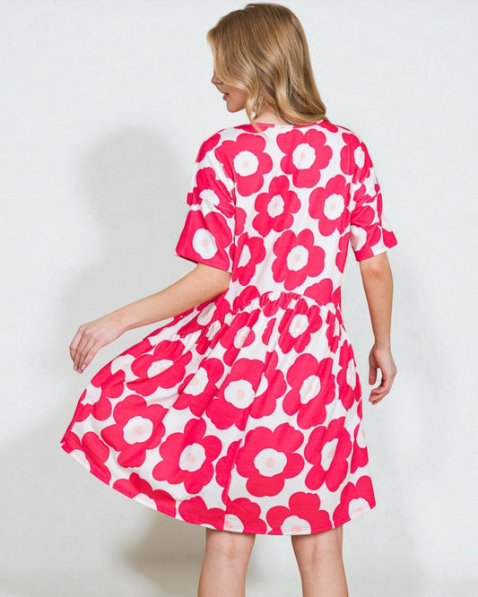 Woman wearing a pink floral dress on a white background
