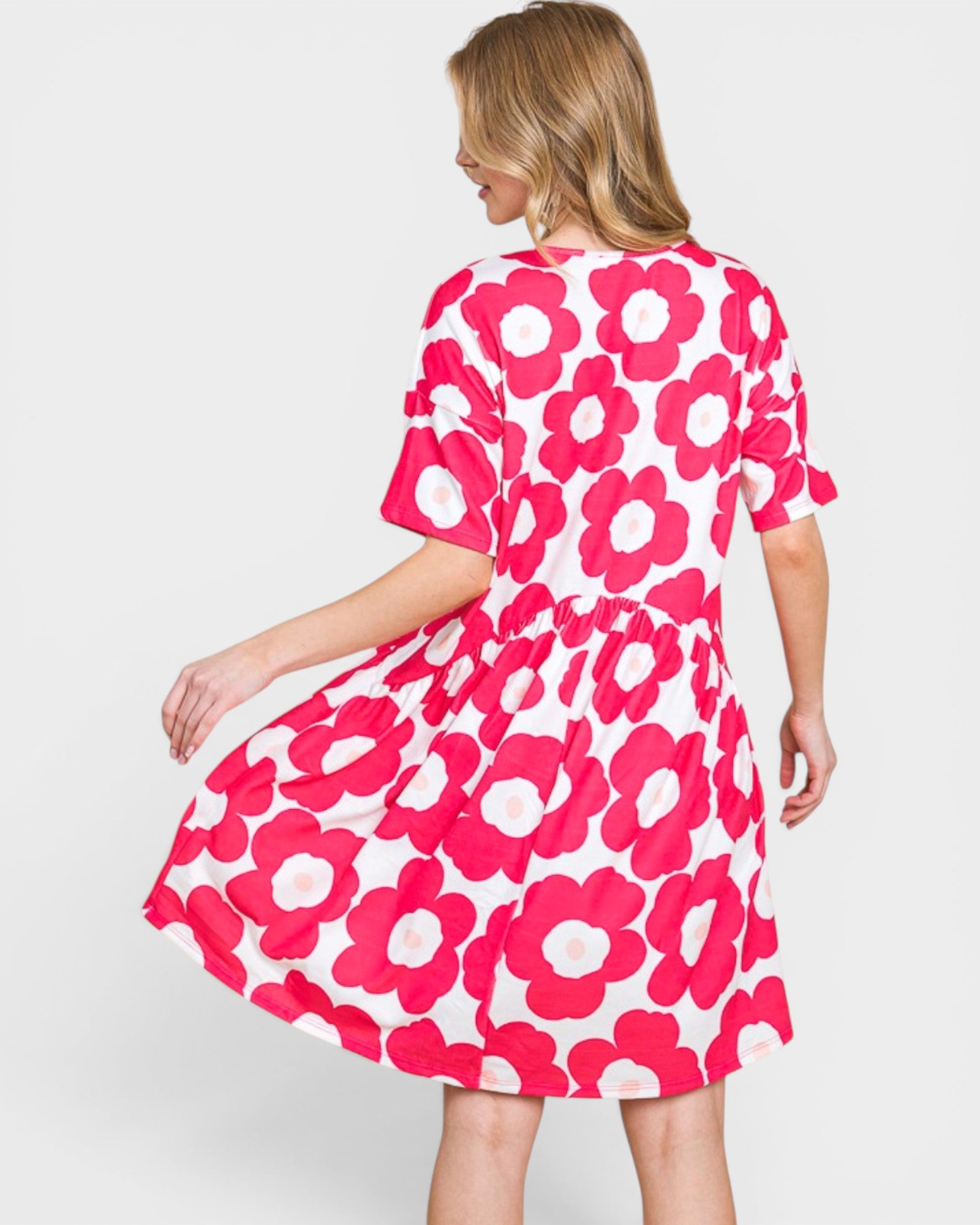 Woman wearing a pink floral dress on a white background