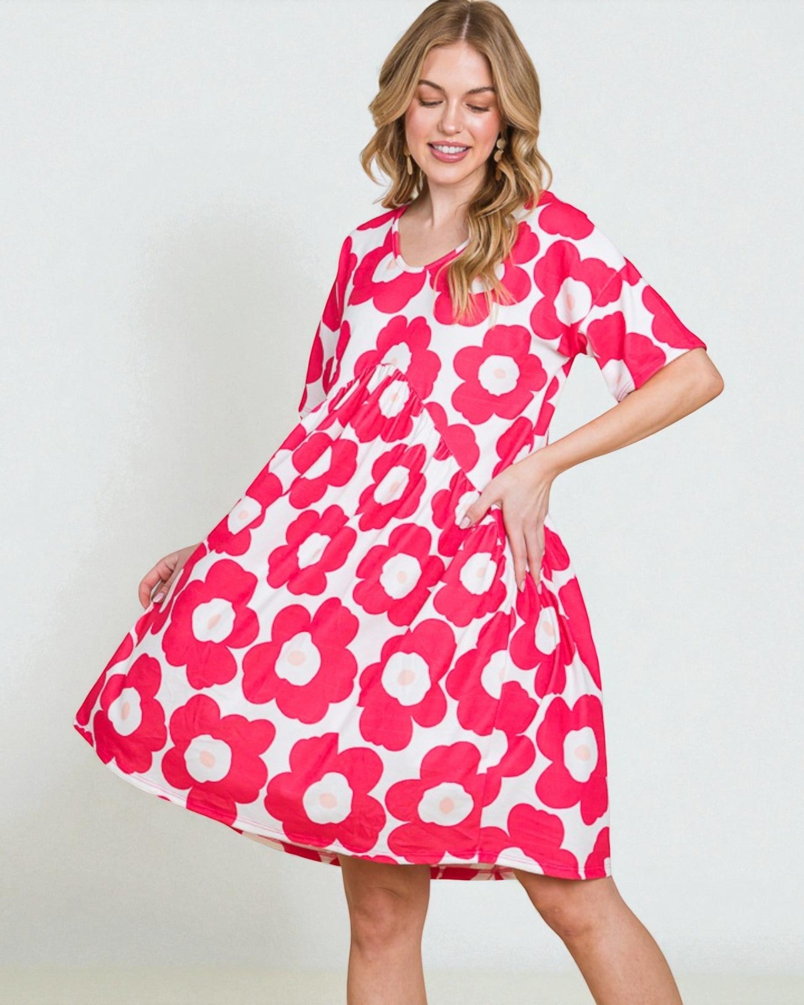 Woman wearing a pink floral dress against a white background
