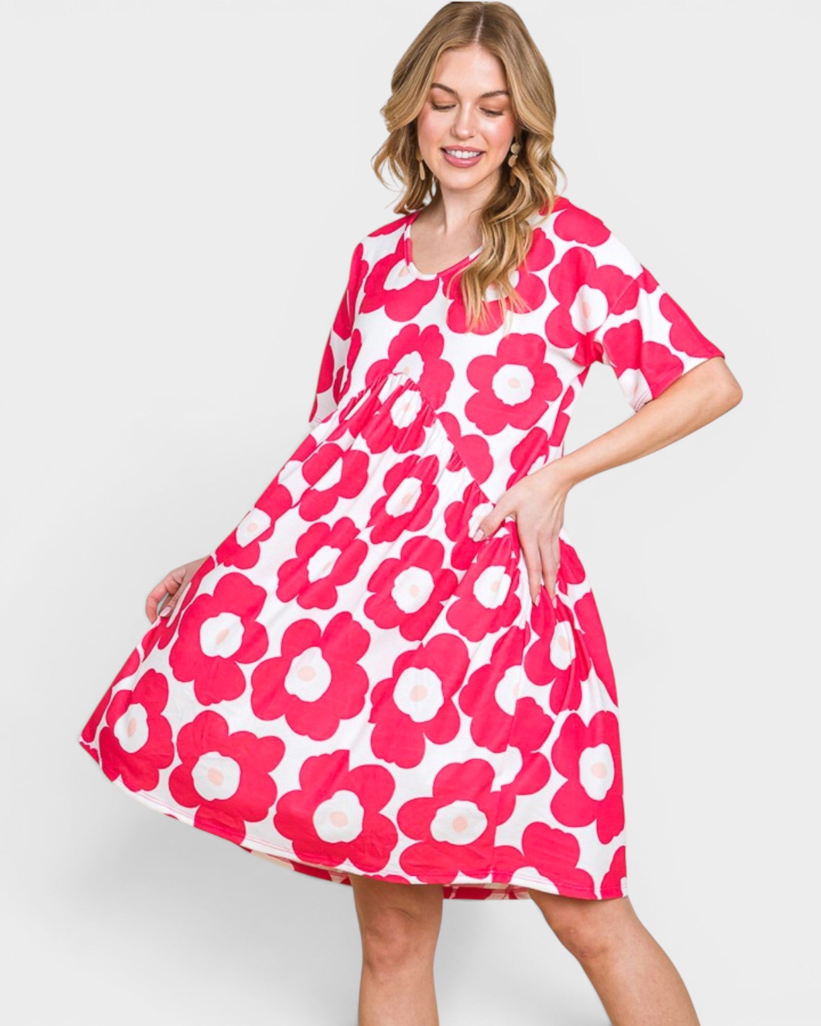 Woman wearing a pink floral dress on a white background