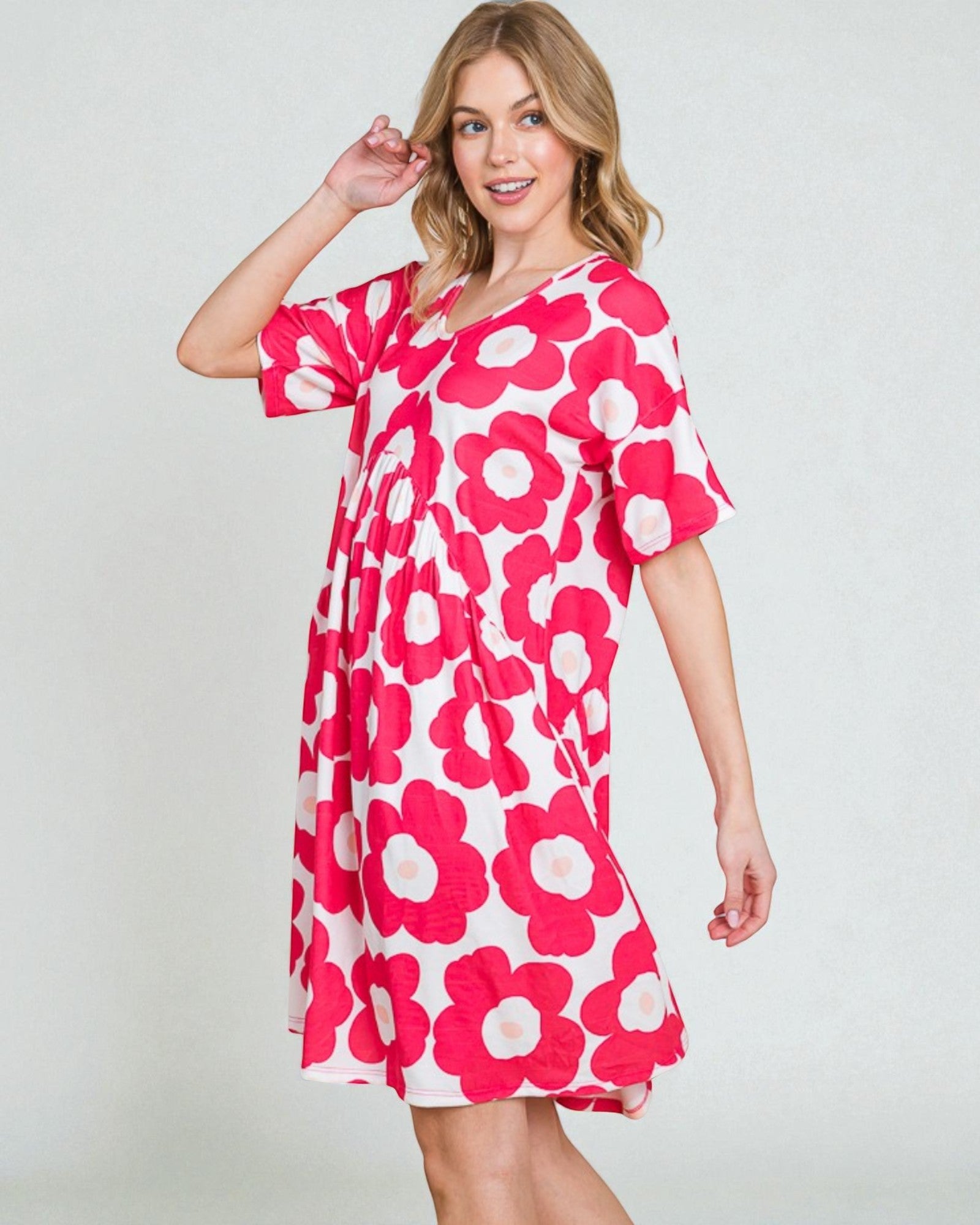 Woman wearing a pink floral dress on a white background