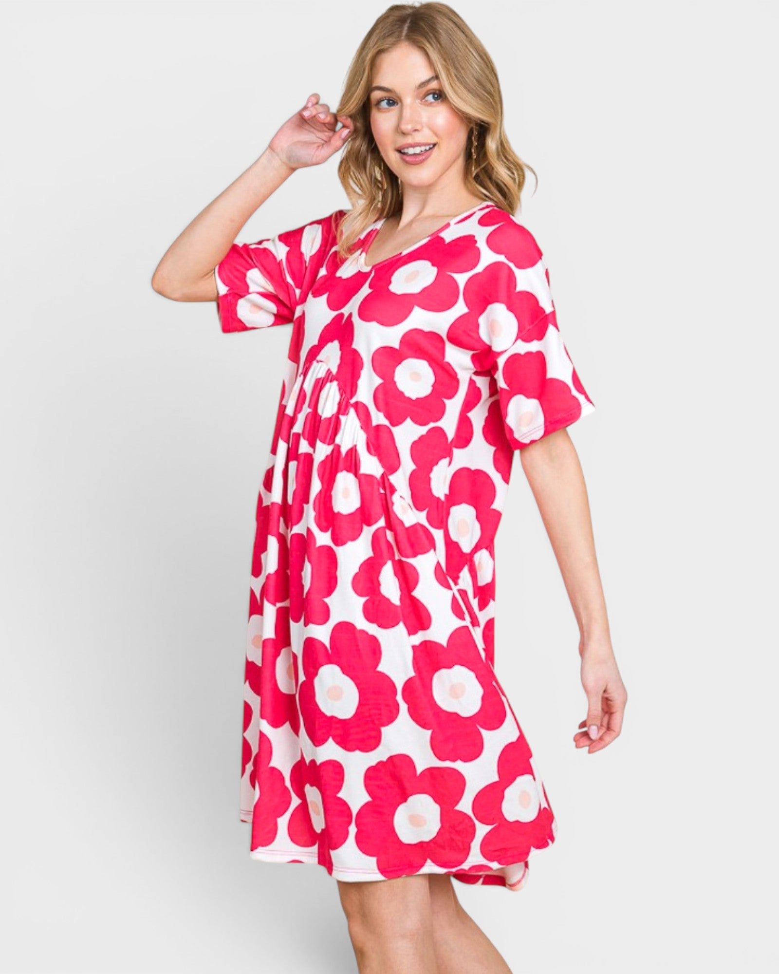 Woman wearing a pink floral dress on a white background