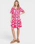 Woman wearing a pink floral dress on a white background