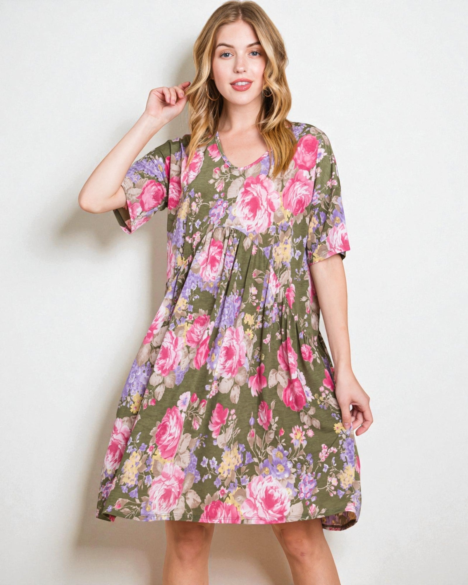 Woman wearing a floral dress against a white background
