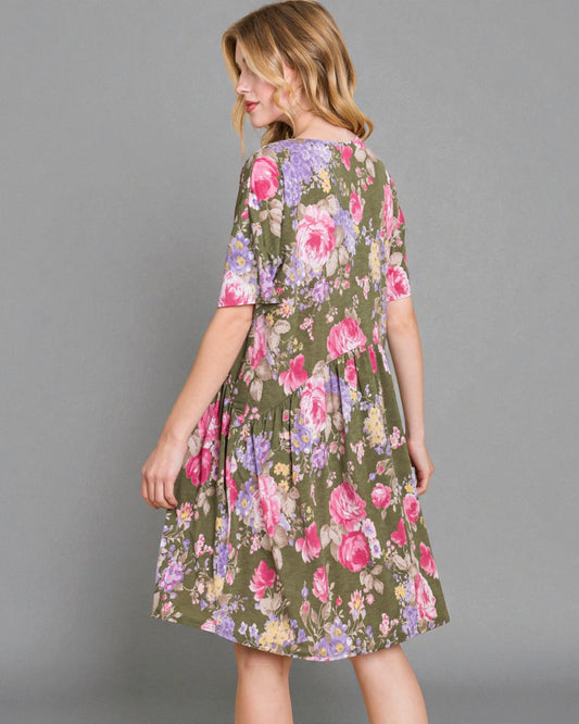 Woman wearing a floral dress on a gray background