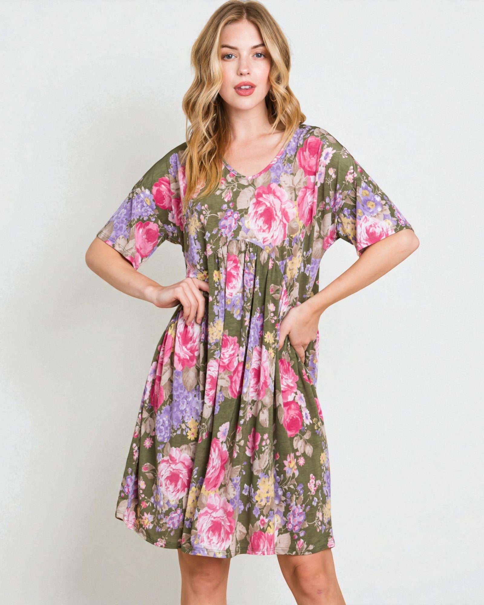 Woman wearing a floral dress with a plain background