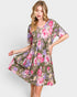 Woman wearing a floral dress on a white background