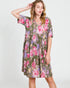 Woman wearing a floral dress on a white background