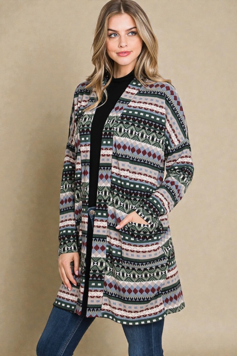 Woman wearing a patterned cardigan against a beige background