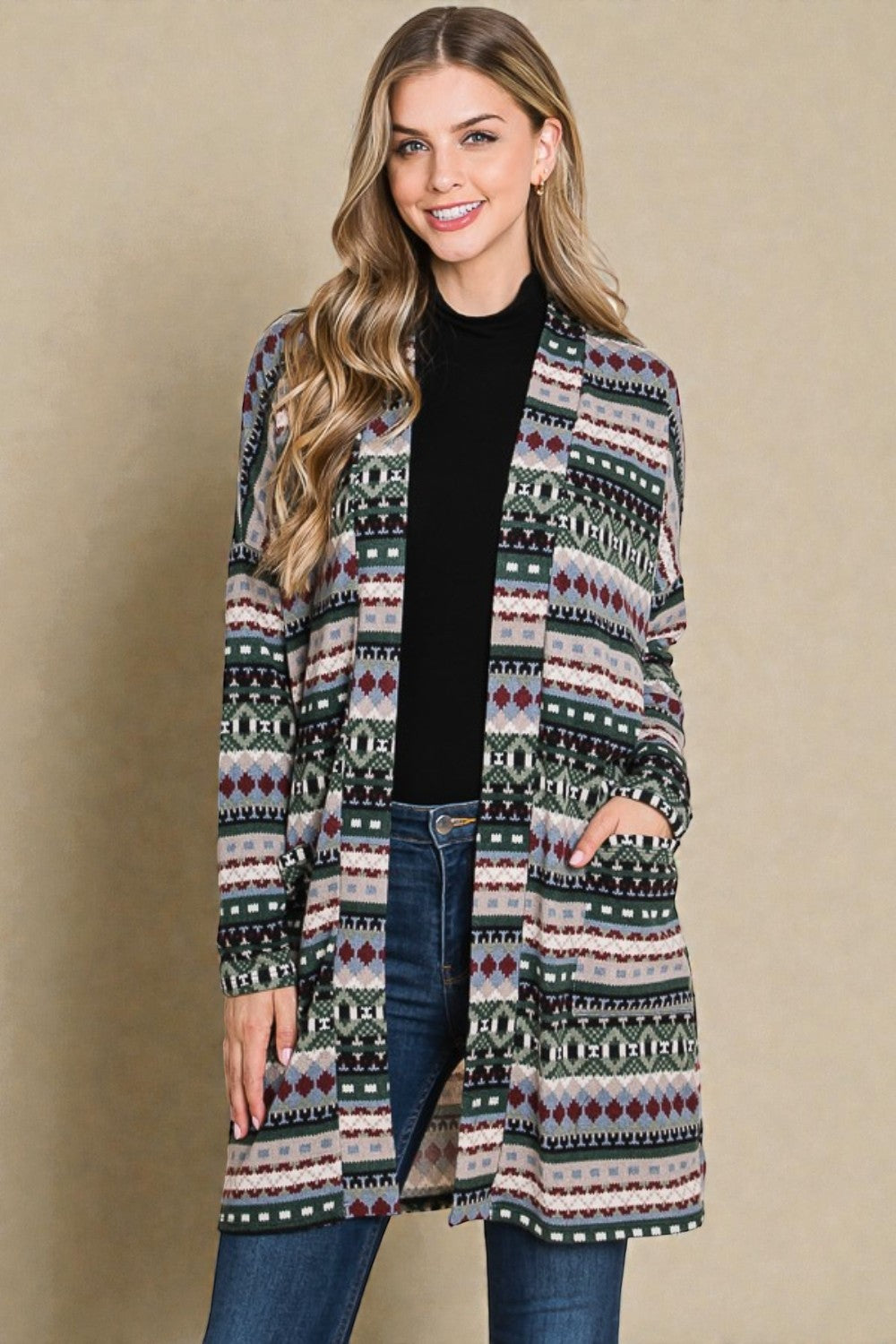 Woman wearing a patterned cardigan against a beige background