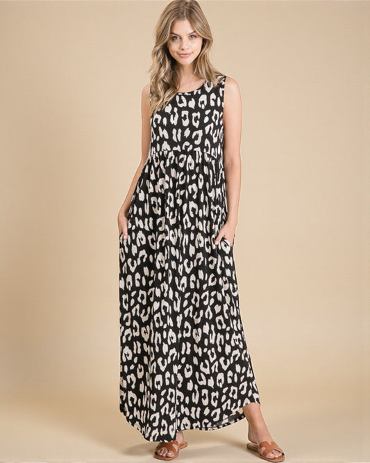 Woman wearing a black and white leopard print dress on a beige background