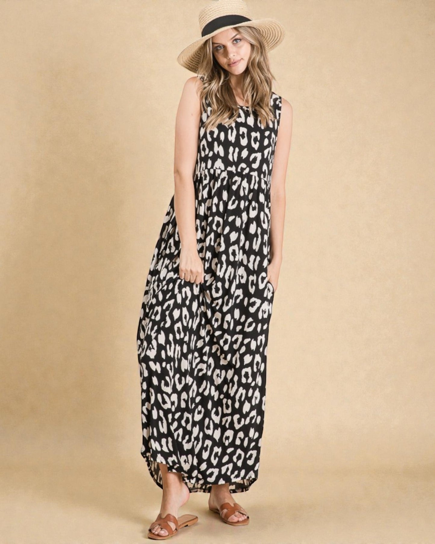 Woman wearing a black and white leopard print dress with a beige background