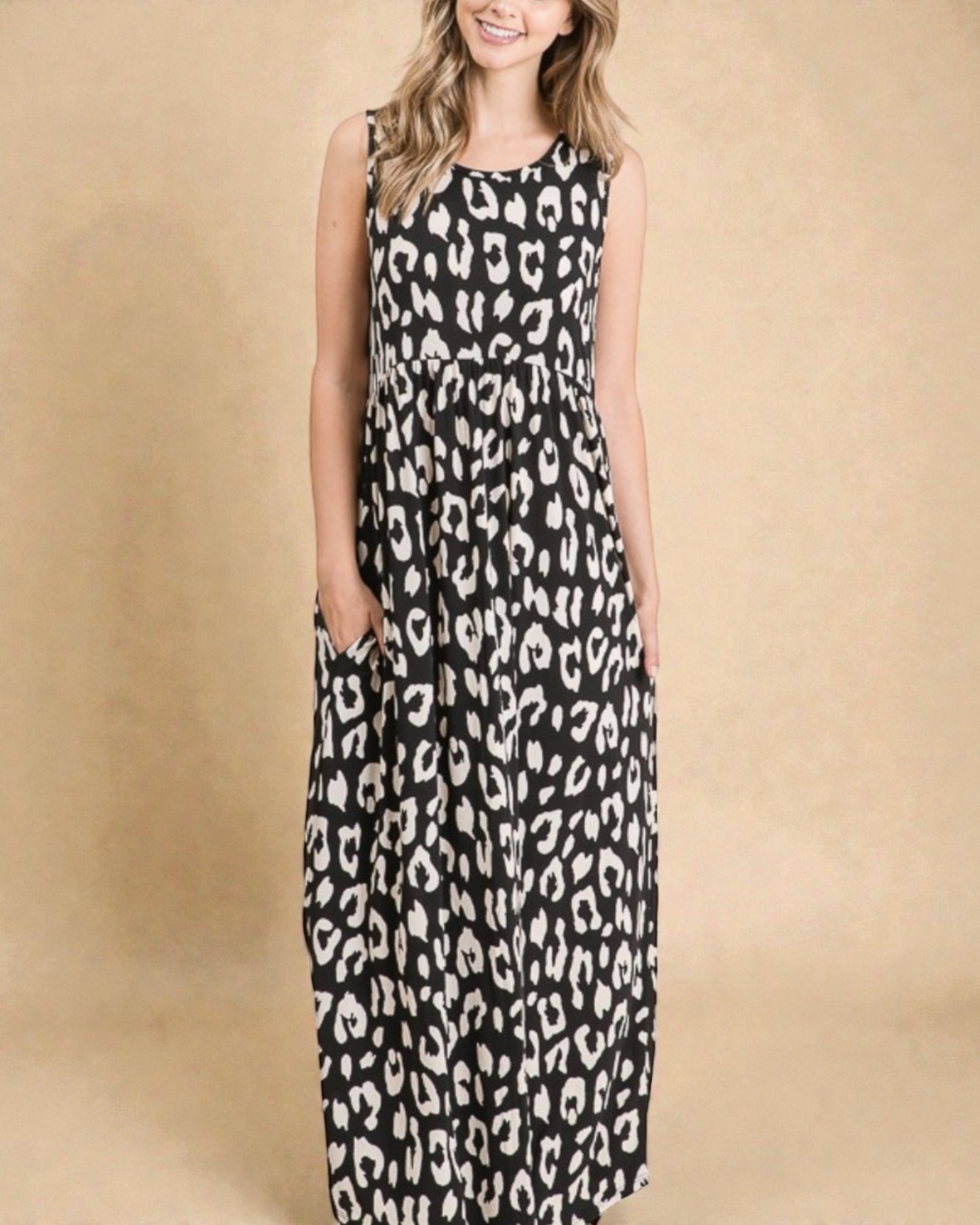 Woman wearing a black and white leopard print dress on a beige background